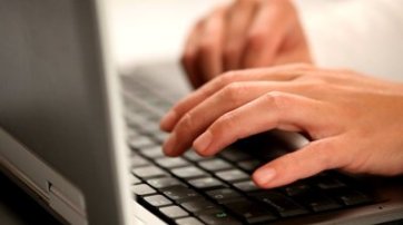 stock-footage-hands-typing-on-a-laptop-keyboard